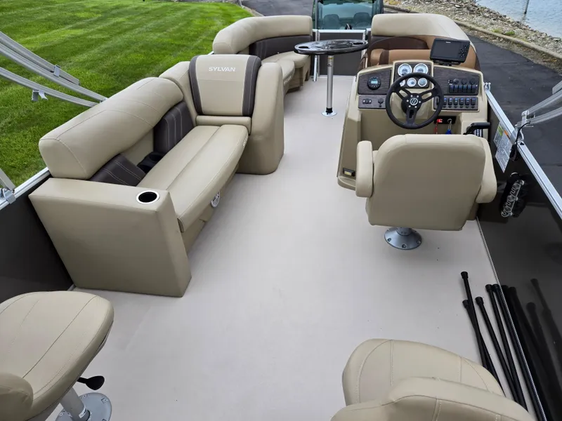 Slide: The Image of 2022 Sylvan Mirage Fish 822 Party Fish boat interior with beige seating and control panel. - 21