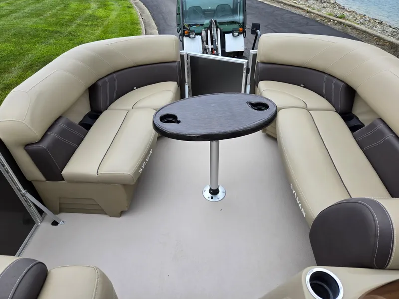 Slide: The Image of 2022 Sylvan Mirage Fish 822 Party Fish boat interior with beige seating and round table. - 24