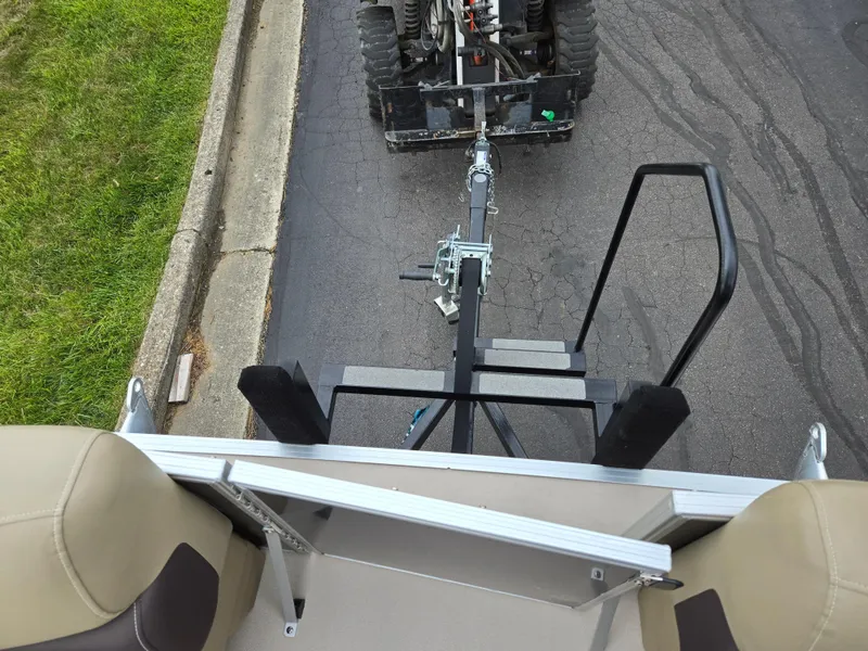 Slide: The Image of Top view of a 2022 Sylvan Mirage Fish 822 Party Fish being towed on a road. - 25