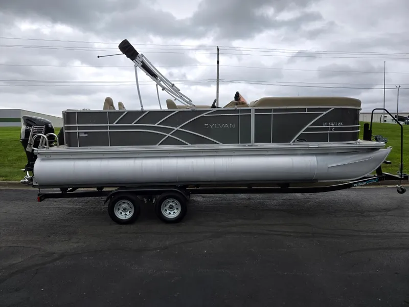 Slide: The Image of 2022 Sylvan Mirage Fish 822 Party Fish pontoon boat on trailer, overcast sky. - 4