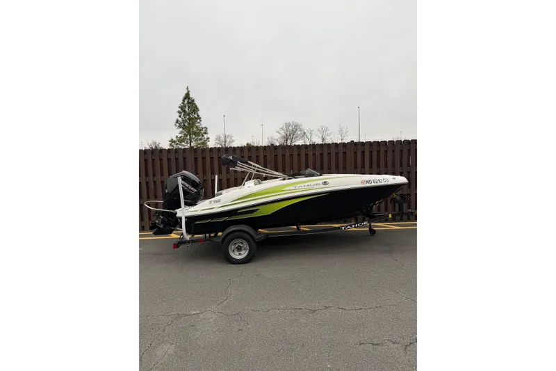 The Image of 2024 Tahoe T16 boat on trailer, parked outdoors, side view. - 1