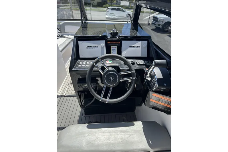 Slide: The Image of 2024 L'acqua Royale LR280 GRAN CABRIO boat dashboard with steering wheel and Mercury displays. - 35