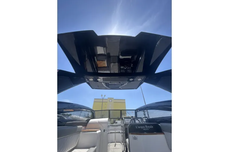 Slide: The Image of 2024 L'acqua Royale LR280 GRAN CABRIO yacht interior with open roof under clear blue sky. - 40