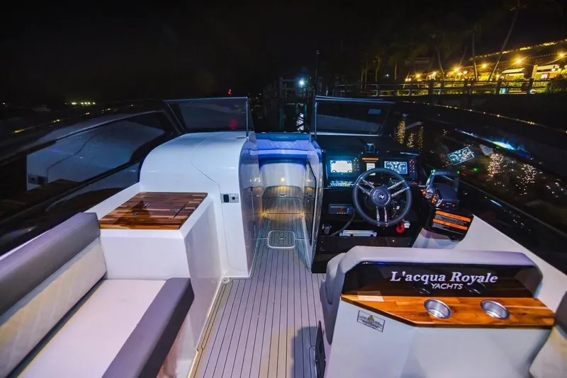 Slide: The Image of 2024 L'acqua Royale LR280 GRAN CABRIO yacht interior at night, featuring modern controls and seating. - 5