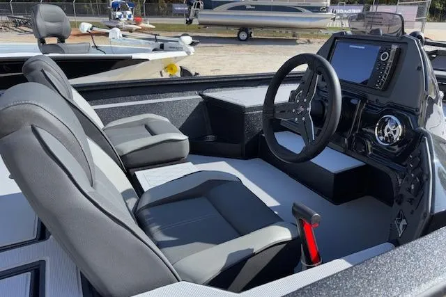 Slide: The Image of 2026 Xpress H18C Crappie boat interior with steering wheel and seating. - 10