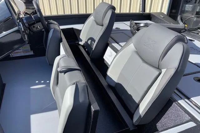 Slide: The Image of 2026 Xpress H18C Crappie boat interior with gray seating and steering wheel. - 13