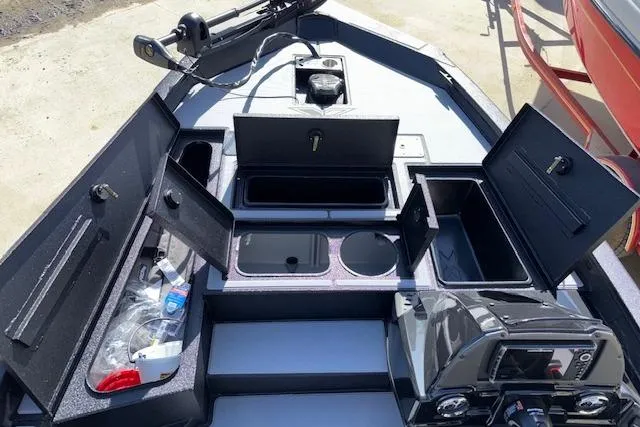 Slide: The Image of 2026 Xpress H18C Crappie boat interior with open storage compartments and control panel. - 14