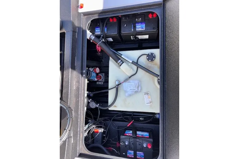 Slide: The Image of 2026 Xpress H18C Crappie boat battery compartment with wiring and components. - 19