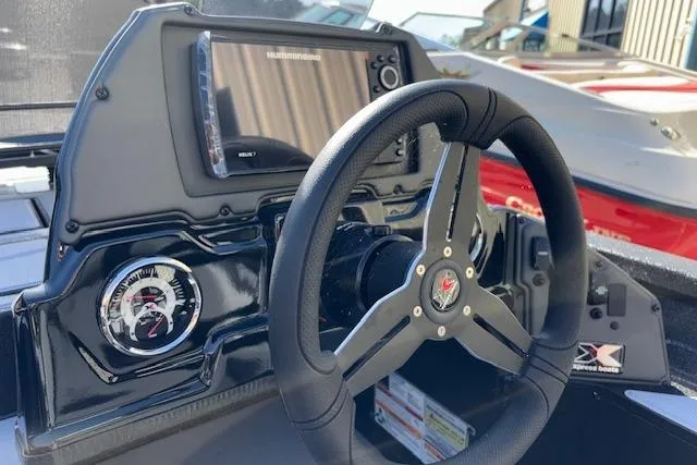 Slide: The Image of Steering console of 2026 Xpress H18C Crappie boat with modern controls and display. - 21