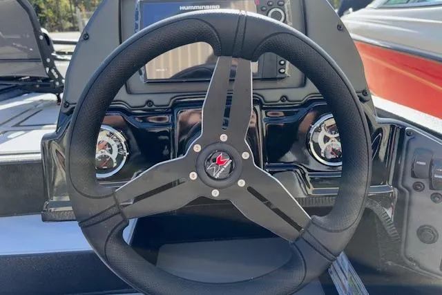 Slide: The Image of Steering wheel of 2026 Xpress H18C Crappie boat with dashboard controls. - 22