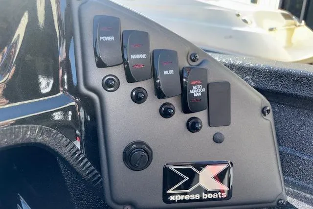 Slide: The Image of Control panel of 2026 Xpress H18C Crappie boat with labeled switches. - 23