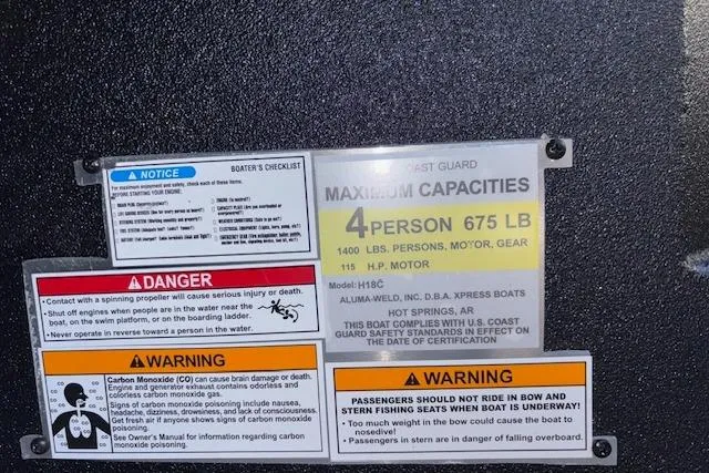 Slide: The Image of Boat capacity and safety labels on a 2026 Xpress H18C Crappie, detailing weight and passenger limits. - 27