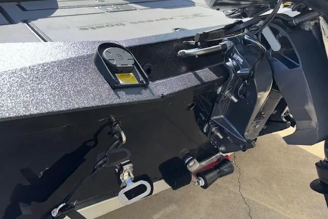 Slide: The Image of 2026 Xpress H18C Crappie boat rear view with motor and accessories. - 30