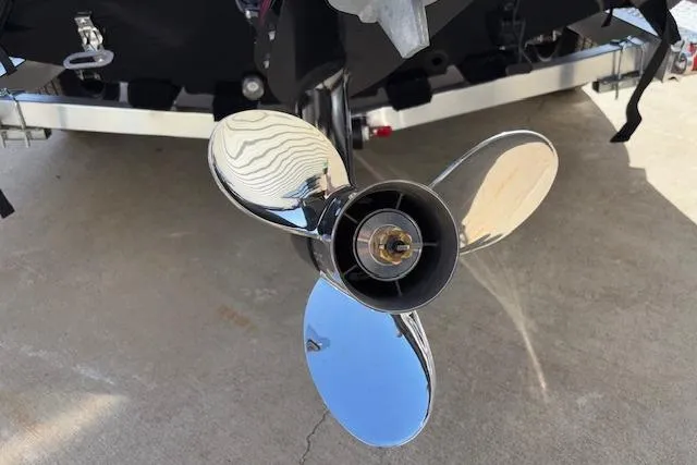 Slide: The Image of 2026 Xpress H18C Crappie boat propeller, shiny metal blades on concrete surface. - 32