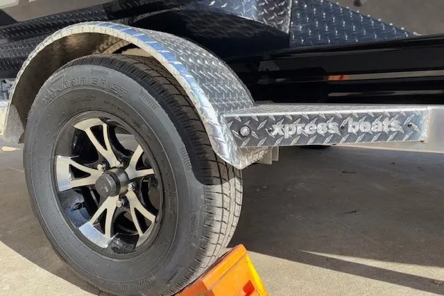 Slide: The Image of 2026 Xpress H18C Crappie boat trailer with diamond plate fender and stylish wheel design. - 34