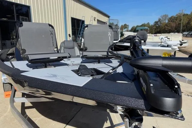 Slide: The Image of 2026 Xpress H18C Crappie boat with dual seats and trolling motor, parked outdoors. - 35