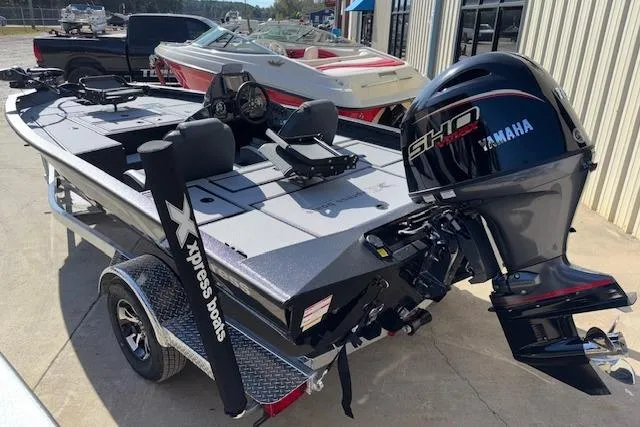 Slide: The Image of 2026 Xpress H18C Crappie boat with Yamaha engine, parked on a trailer. - 6