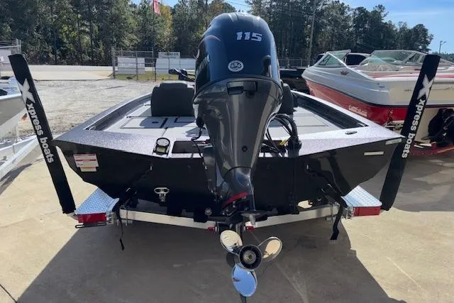 Slide: The Image of 2026 Xpress H18C Crappie boat with 115 HP motor, parked outdoors. - 7