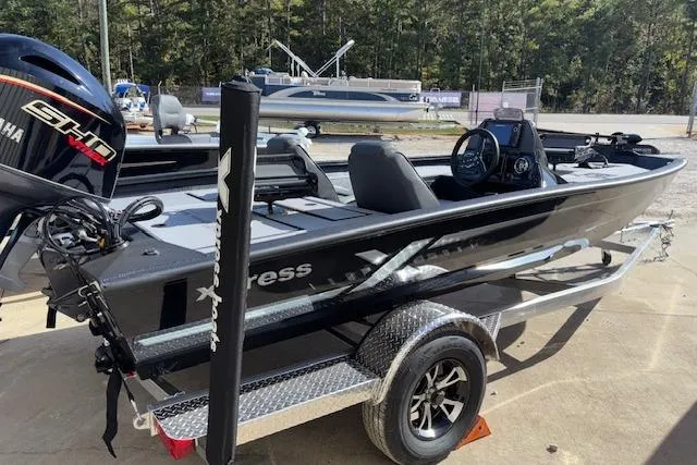 Slide: The Image of 2026 Xpress H18C Crappie boat on trailer, featuring sleek design and Yamaha engine. - 9