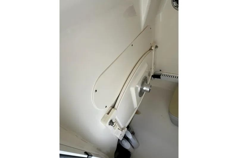 Slide: The Image of 2014 Boston Whaler Dauntless 240 interior detail, showcasing storage compartment and fittings. - 10