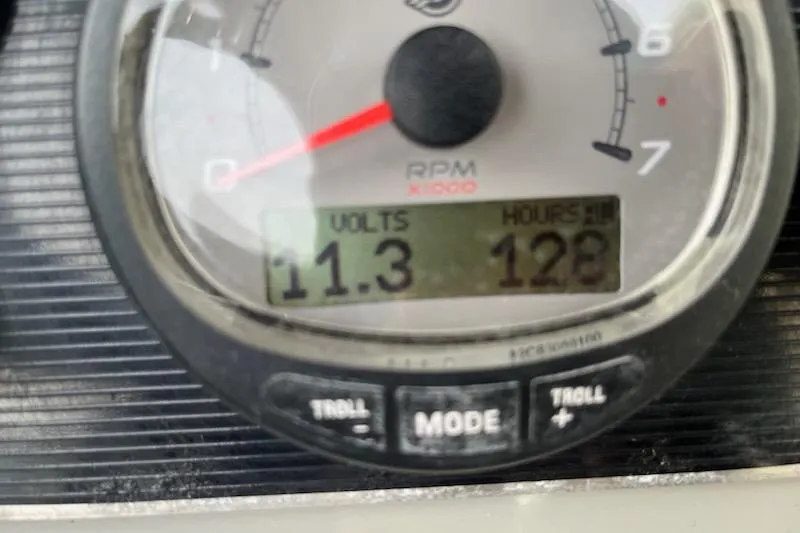 Slide: The Image of Close-up of a 2014 Boston Whaler Duantless 240 gauge showing 11.3 volts and 128 hours. - 11