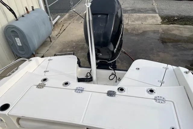 Slide: The Image of 2014 Boston Whaler Dauntless 240 boat stern with outboard motor and rod holders. - 6