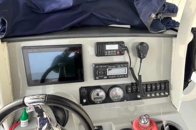 Slide: The Image of 2014 Boston Whaler Dauntless 240 dashboard with navigation and communication equipment. - 8