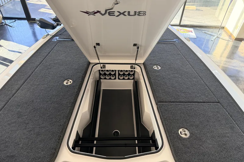 Slide: The Image of 2026 Vexus VXS20 boat storage compartment with open lid and organized interior. - 15