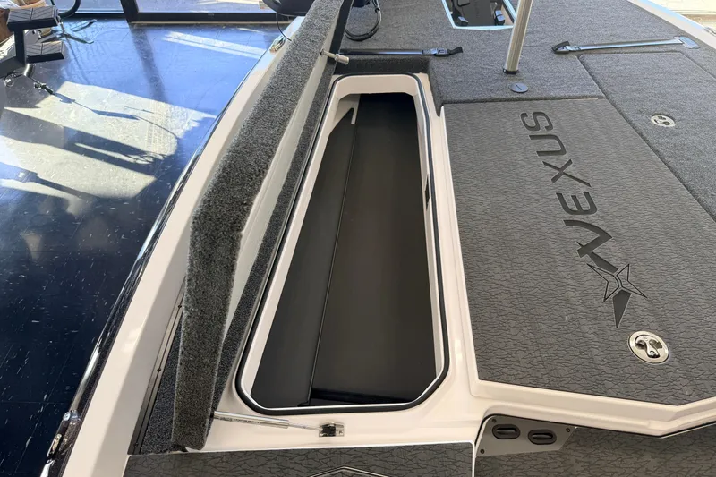 Slide: The Image of 2026 Vexus VXS20 boat interior with open storage compartment and logo. - 16
