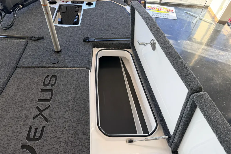 Slide: The Image of 2026 Vexus VXS20 boat interior with open storage compartment and carpeted flooring. - 18