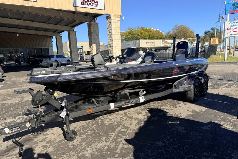 Slide: The Image of 2026 Vexus VXS20 boat on trailer outside dealership, featuring Garmin equipment. - 2