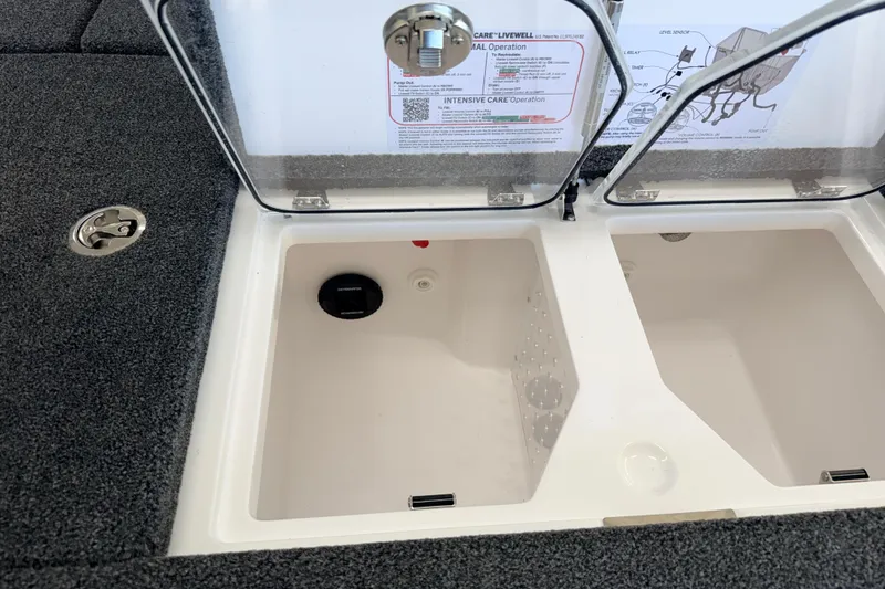 Slide: The Image of 2026 Vexus VXS20 boat livewell compartments with open lids and instruction labels. - 26