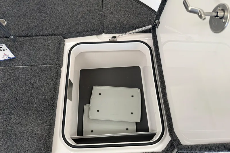 Slide: The Image of Open storage compartment in 2026 Vexus VXS20 boat, featuring carpeted interior and secure latch. - 30