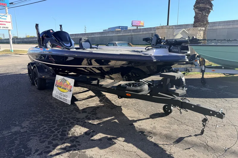 Slide: The Image of 2026 Vexus VXS20 boat on trailer, parked outdoors, featuring sleek black design. - 5