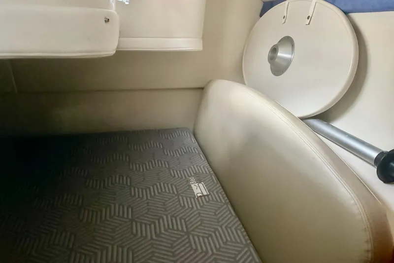 Slide: The Image of Interior of 2009 Bayliner 285 Cruiser with patterned flooring and seating. - 13