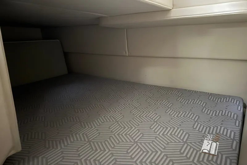 Slide: The Image of 2009 Bayliner 285 Cruiser interior cabin with patterned mattress. - 14