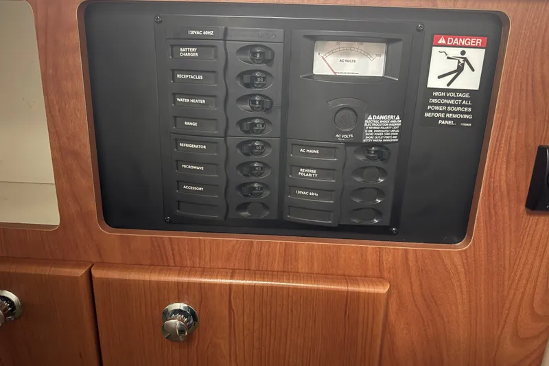 Slide: The Image of Electrical control panel on 2009 Bayliner 285 Cruiser boat, featuring various switches and voltage meter. - 16