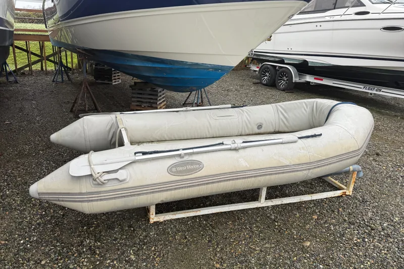 Slide: The Image of Inflatable boat beside 2009 Bayliner 285 Cruiser on gravel lot. - 17