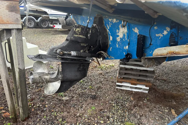 Slide: The Image of 2009 Bayliner 285 Cruiser boat propeller and stern drive on dry land. - 18