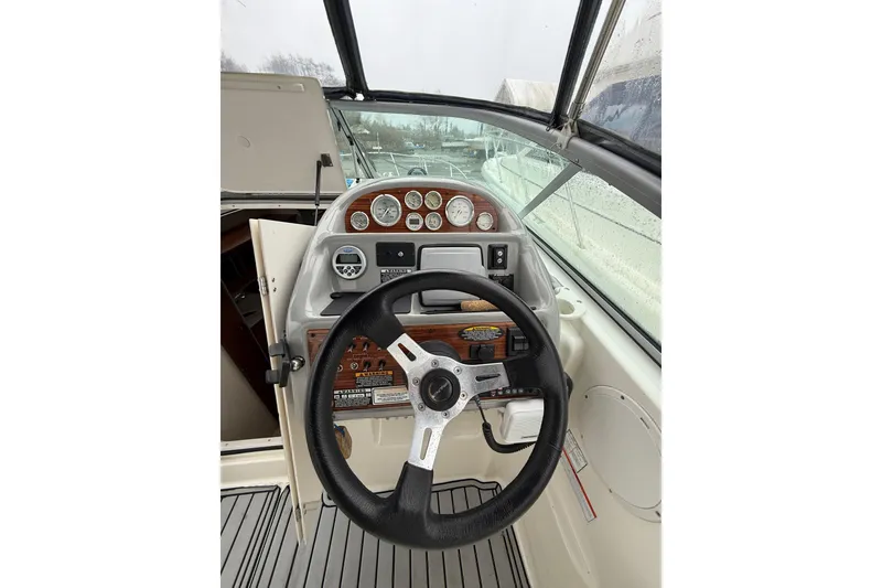 Slide: The Image of 2009 Bayliner 285 Cruiser helm with steering wheel and instrument panel. - 6