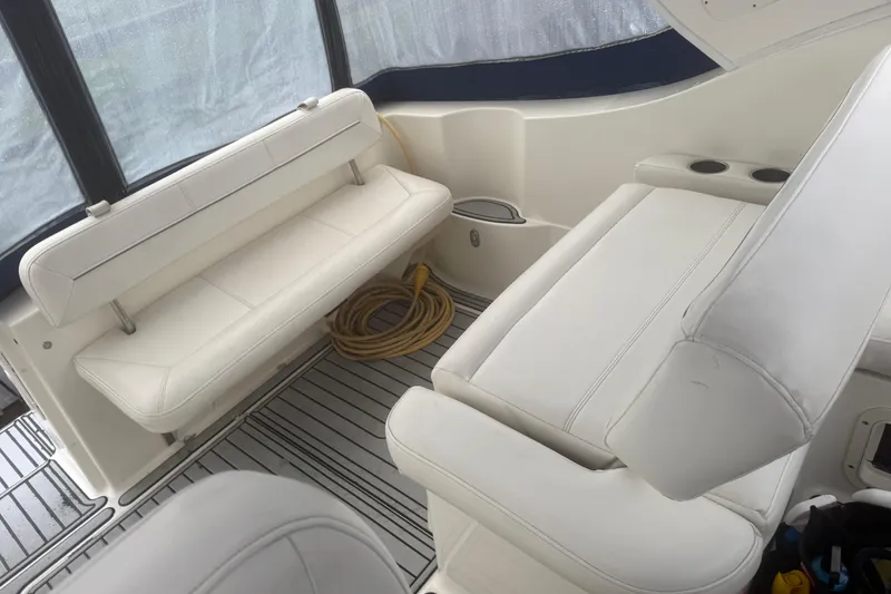 Slide: The Image of 2009 Bayliner 285 Cruiser interior with white seating and coiled rope. - 8