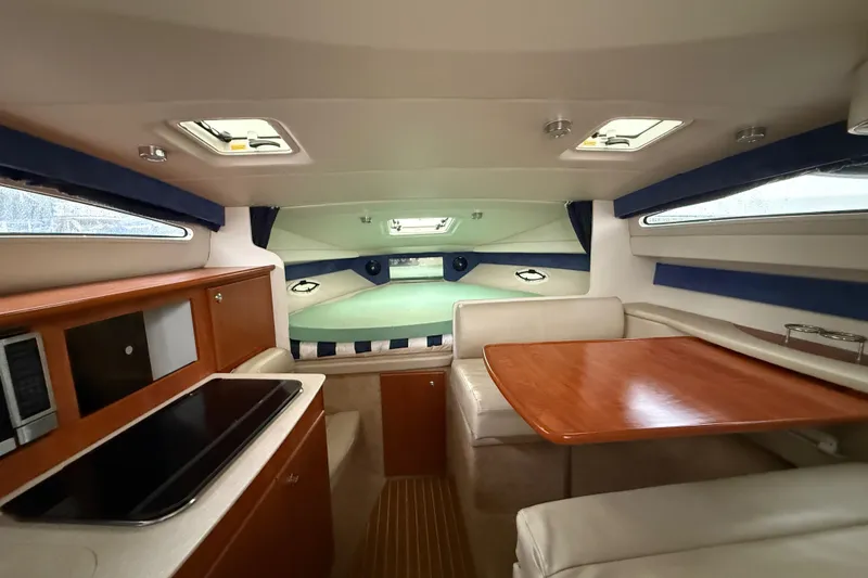 Slide: The Image of 2009 Bayliner 285 Cruiser interior with dining area and kitchenette. - 9