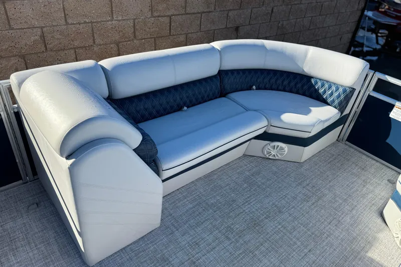 Slide: The Image of Luxurious seating on 2023 Nepallo 22TL boat, featuring blue and white upholstery. - 11