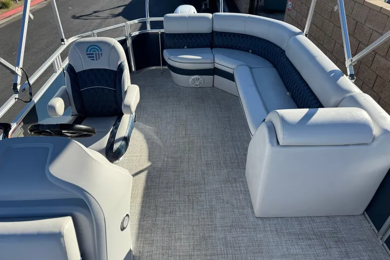 Slide: The Image of 2023 Nepallo 22TL pontoon boat interior with plush seating and steering console. - 14