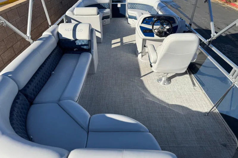 Slide: The Image of 2023 Nepallo 22TL pontoon boat interior with plush seating and modern helm. - 18