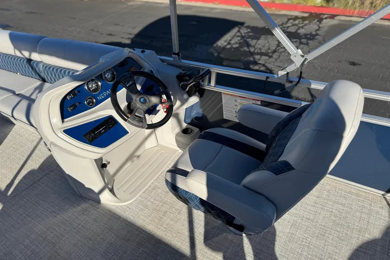 Slide: The Image of 2023 Nepallo 22TL boat interior with steering wheel and captain's chair. - 19
