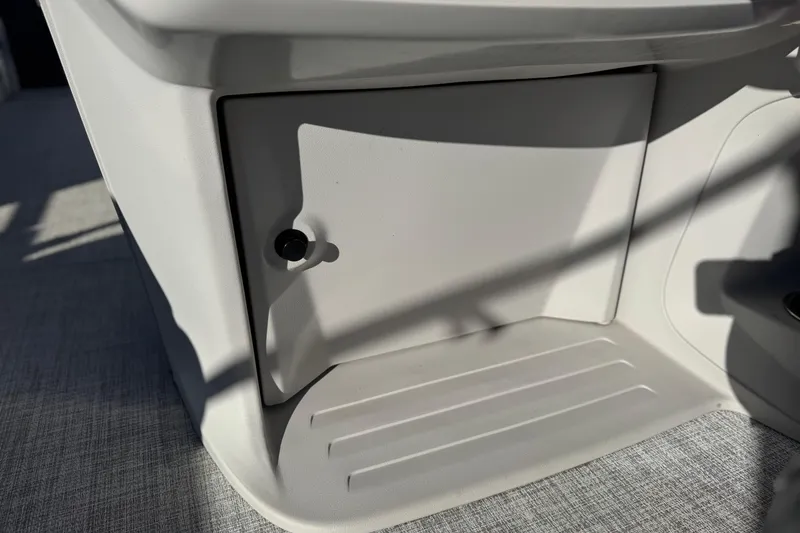 Slide: The Image of 2023 Nepallo 22TL boat storage compartment with secure latch and sleek design. - 22