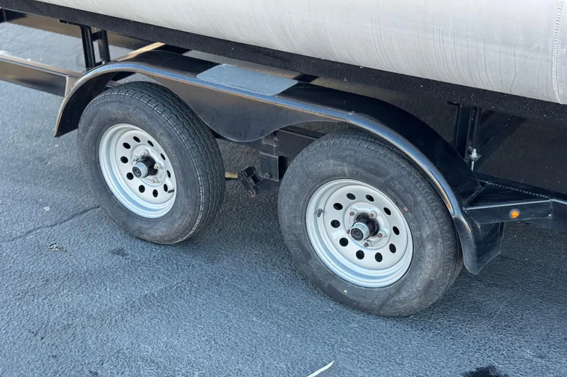 Slide: The Image of Dual wheels of a 2023 Nepallo 22TL trailer on asphalt surface. - 24