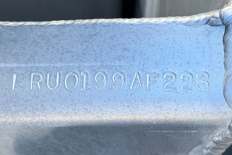 Slide: The Image of Close-up of Nepallo 22TL 2023 model serial number FRU0199AF223 engraved on metal surface. - 26