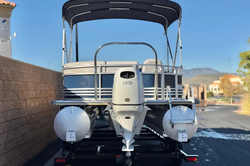 Slide: The Image of 2023 Nepallo 22TL pontoon boat with canopy and outboard motor, parked on trailer. - 5